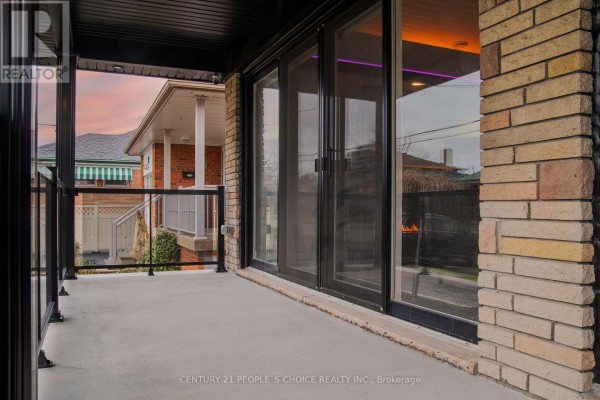 Covered porch with glass railings overlooking the street and houses. - Upper - 37 Bentworth Avenue, Toronto