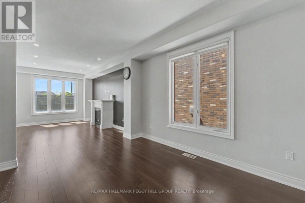 Open concept living area with large windows and dark wood floors. - Upper - 53 Nathan Crescent, Barrie