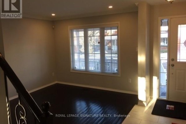 Interior entryway with dark hardwood floors and a large window with blinds. - Upper - 7092 Walworth Court, Mississauga