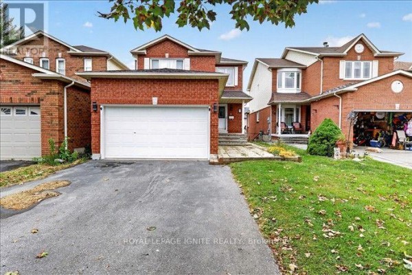 Front view of a red brick house with a wide driveway and attached garage. - Upper - 8 Vail Meadows Crescent, Clarington