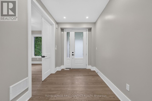 Interior entryway with grey walls, white trim, and dark hardwood floors. - Upper - 933 7th Line, Innisfil
