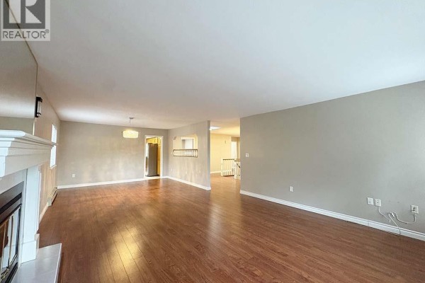 View of the living room, dining area, and hallway to upstairs. - Upper 5225 Canada Way, Burnaby