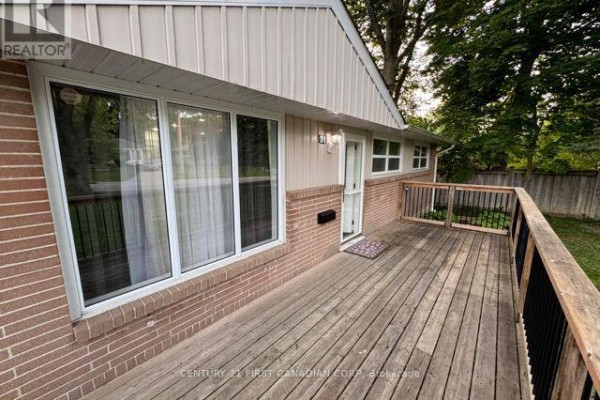 Close-up of wooden deck with railing and brick exterior. - Upper Level - 31 Thorncrest Crescent, London South