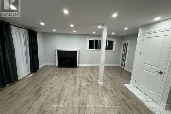 Living room with gray walls, fireplace, and laminate flooring. - Upper Level - 31 Thorncrest Crescent, London South