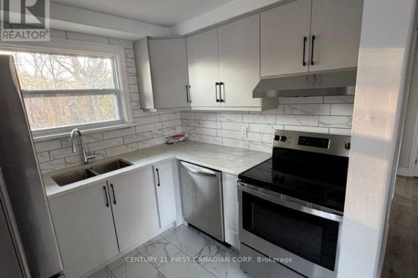Kitchen with stainless steel appliances, white cabinets, and marble countertops. - Upper Level - 31 Thorncrest Crescent, London South