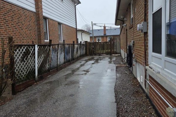 A spacious living room with hardwood floors, white trim, and large windows covered by sheer curtains. - Upper Only - 478 Brimley Road, Toronto