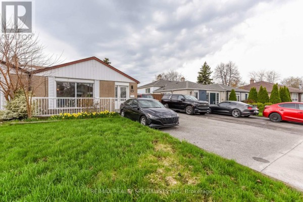 Driveway with multiple cars including black sedan and dark SUV in front of bungalow. - Upper Portion - 137 Avondale Boulevard, Brampton