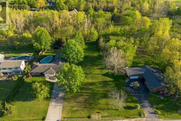 Distant aerial view of a wooded area and homes bordered by snow-covered fields and treelines. - V/l Bissonnette Lane, Lakeshore