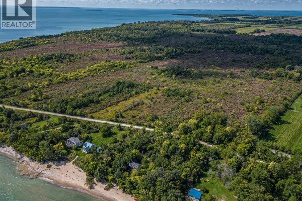 Expansive view of a coastal property with trees, houses, and the ocean. - V/l Cooper Road, Pelee Island