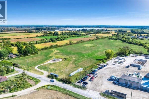 Aerial view of a rural intersection with a large cleared lot on the right and a road on the left. - V/l Mersea Road 5, Leamington