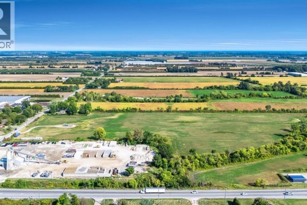 Aerial view of a vast agricultural landscape with scattered buildings and a highway in the distance. - V/l Mersea Road 5, Leamington