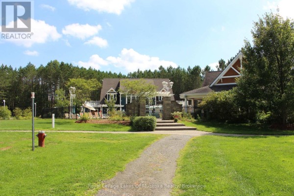 Entrance to a large property with landscaped gardens and a stone pathway. - V1, W1 - 1020 Birch Glen Road, Lake Of Bays