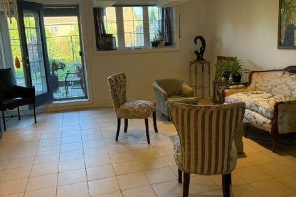 Basement living area with French doors leading outside, tiled floor, and seating. - W/o Basement - 21 Bristlewood Crescent, Vaughan