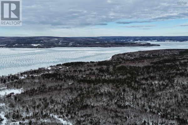 Similar panoramic view of Lake Ainslie, highlighting the icy shoreline and surrounding terrain. - West Lake Ainslie Road, Lake Ainslie