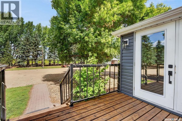 View from a wooden deck with black metal railing and a glass door. - Williams Acreage, Wolverine Rm No  340