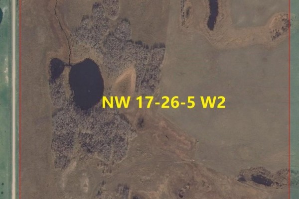 Close-up aerial view of a parcel of land showing a pond and wooded area. - Yorkton Aggregate Quarter Rm 244, Orkney Rm No  244