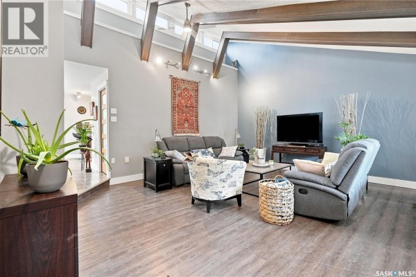 Interior view of a bright entryway with a white door, wooden bench, and potted plants. - Zehner,rm Edenwold No 158 -fabian Acreage,80 Acres, Edenwold Rm No 158